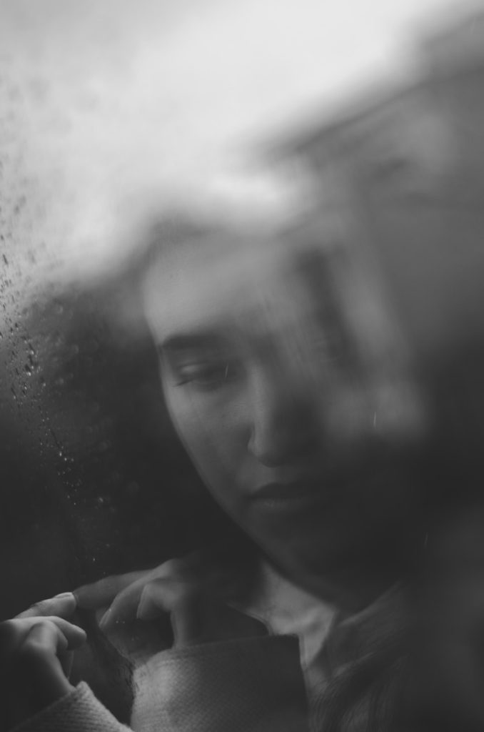 greyscale photo of woman inside car